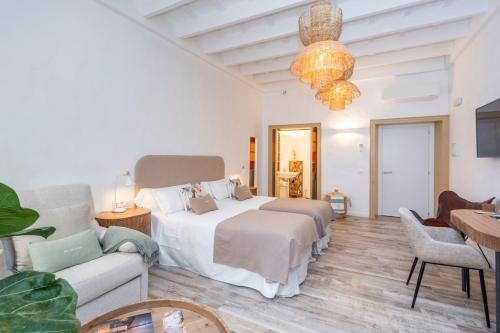 a bedroom with two beds and a couch at Encant de Alaior Boutique Hotel in Alaior
