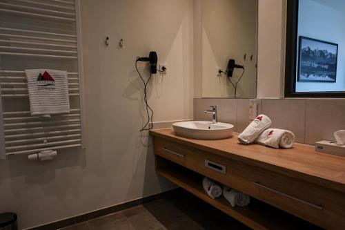 a bathroom with a sink and a mirror at Soloplan City Resort in Kempten