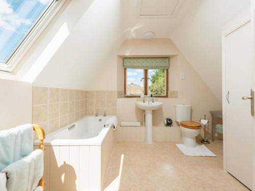 łazienka z wanną, toaletą i umywalką w obiekcie Garden Cottage w mieście Cheltenham