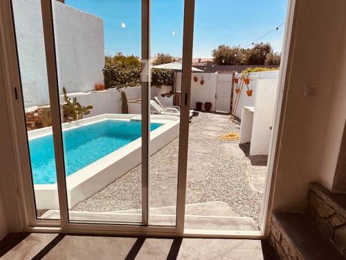 a view of a swimming pool through a window at Paraíso do Corval in São Pedro do Corval