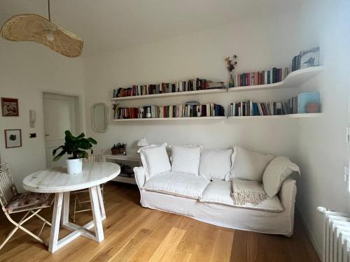 a living room with a white couch and a table at Bloom as you are in Bologna