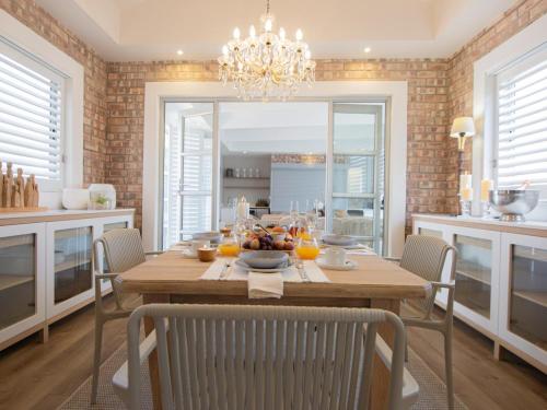a dining room with a wooden table and chairs at Good Karma in Swakopmund
