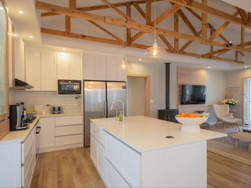 a kitchen with white cabinets and a white counter top at Good Karma in Swakopmund