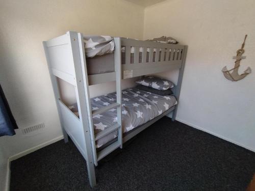 a couple of bunk beds in a room at 19 Seadell in Hemsby