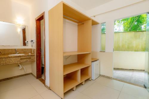 a bathroom with a sink and a mirror at Miola Hotel in Porto Seguro