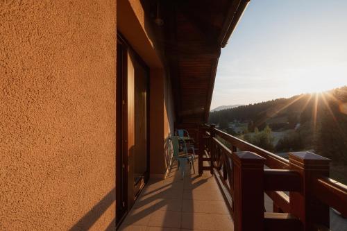 a balcony of a house with the sun in the background at Hotel Green in Dolný Kubín