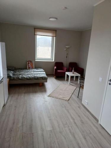 a living room with a bed and a table at Nadmar hostel apartment, no.1 in Kuressaare