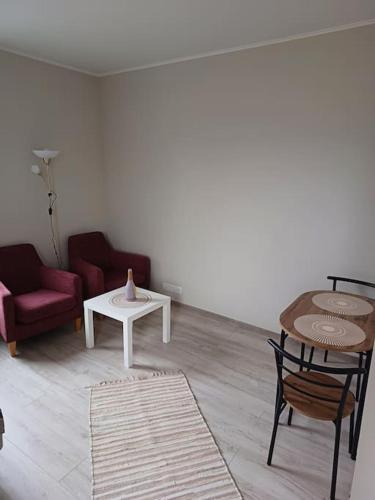 a living room with a couch and a table at Nadmar hostel apartment, no.1 in Kuressaare
