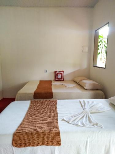 Säng eller sängar i ett rum på Chalé Ilha Verde-Cumuruxatiba