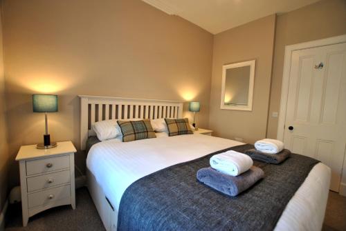 a bedroom with two beds and two night stands at The Old Surgery Crail- welcoming apartment in Crail