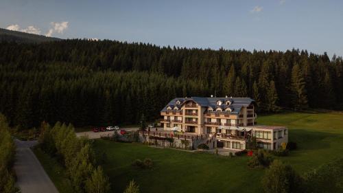 an aerial view of a large house in a field at Hotel Green in Dolný Kubín