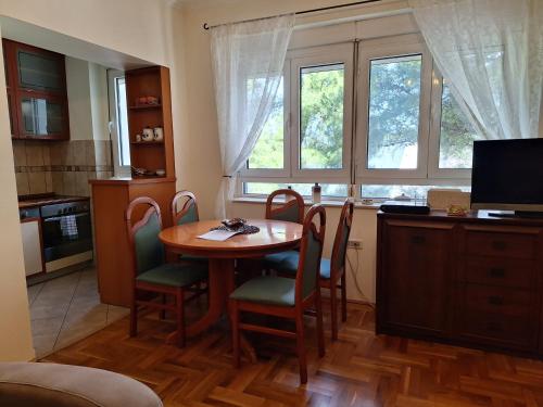 a kitchen with a table and chairs and a window at Apartment Music-center, in the center of Podgorica in Podgorica