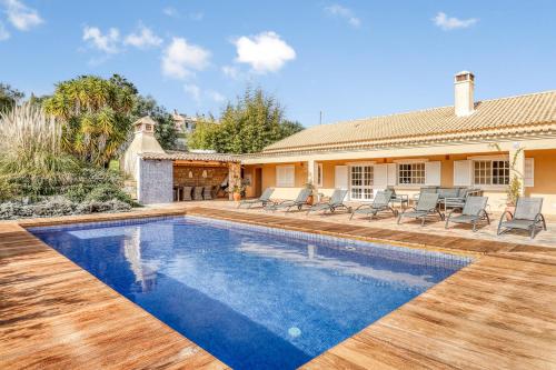 a swimming pool in the backyard of a house at Casa de Apra by Portucasa in Loulé