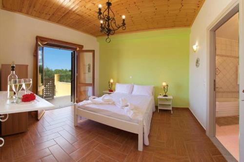 a bedroom with a large bed and a bathroom at Villa Nikos in Karavadhos