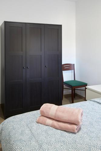 a pink towel sitting on top of a bed at La Caseta del Fai in Riells del Fay