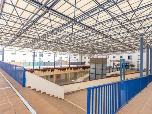 a large building with a train station with people on it at Lux Bormujos - Vacacional Sevilla in Bormujos