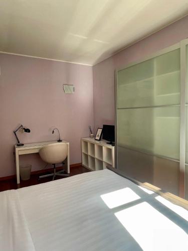 a bedroom with a bed and a desk and a window at Easy Milano - Rooms and Apartments Navigli in Milan