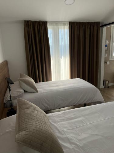 Ένα ή περισσότερα κρεβάτια σε δωμάτιο στο Hostal Márquez