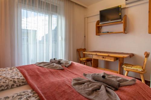 a bedroom with a bed with towels on it at Airport Studio Innsbruck I Free Parking in Innsbruck