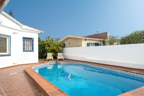 a swimming pool in the backyard of a house at Casa Alegria Carvoeiro in Carvoeiro