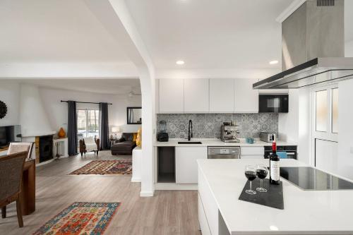 a kitchen with white cabinets and a white counter top at Casa Alegria Carvoeiro in Carvoeiro