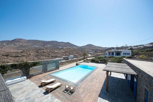 a swimming pool sitting on top of a house at Villa Victoria with Sea View and Two Private Pools in Elia