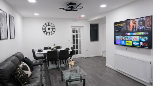 a living room with a couch and a table at ETIHCITY - 3 Bedroom Semi - Free Parking near Etihad Stadium, Tourist attractions, Manchester City Centre, Transport and Motorway Links next to McDonald's - Sky n Netflix in Manchester
