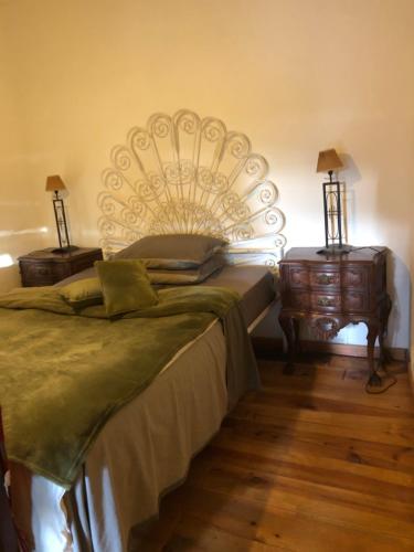a bedroom with a large bed and two night stands at Beautiful small House in Algarve Portugal in Mexilhoeira Grande