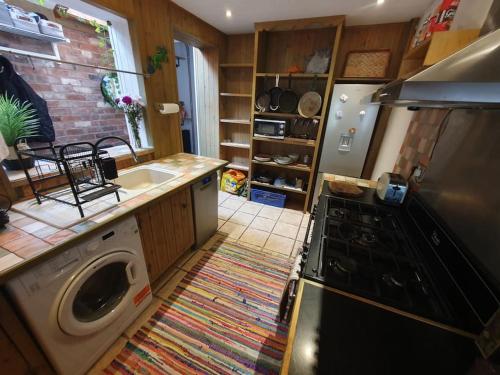 a kitchen with a washing machine and a sink at Sofia's Place in Rugby