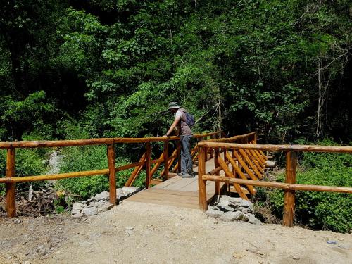 a man standing on a wooden bridge at Park Hotel Bellavista in Gambarie dʼAspromonte