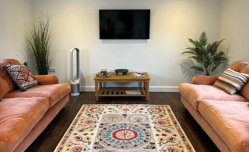 a living room with two couches and a table at Linwood in Lincoln