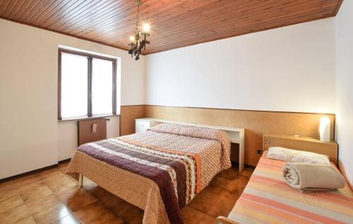 a room with two beds and a window at Beautiful Apartment In Ossimo Superiore in Cividate Camuno