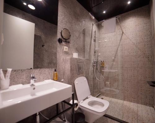 a bathroom with a sink and a toilet and a shower at TbiliSee Hotel in Tbilisi City
