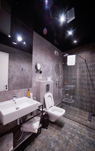 a bathroom with a sink and a toilet and a shower at TbiliSee Hotel in Tbilisi City