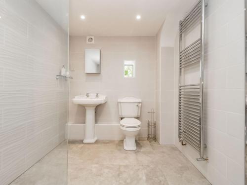 a white bathroom with a toilet and a sink at Braeburn - Uk38098 in Pilton