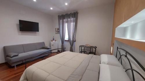 a bedroom with a bed and a couch at Catherine's House in Salerno