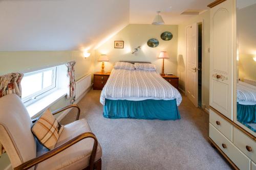 a bedroom with two beds and a window at Lower Cottage Newcastle Emlyn in Cwm-pengraig