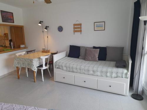 a small bedroom with a bed and a table at Apartment with pool near the beach in Marbella
