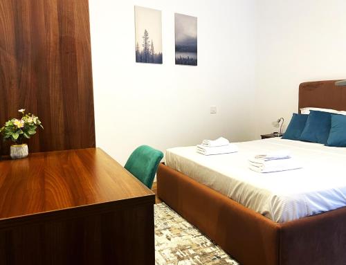 a hotel room with a bed and a desk at Sinaia Walter 20 Apartment w Paid Pool and Free Parking in Sinaia
