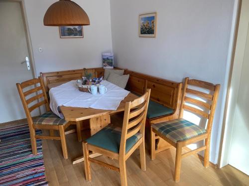 a wooden table and chairs in a room at Ferienhaus Endrös - Chiemgau Karte in Inzell