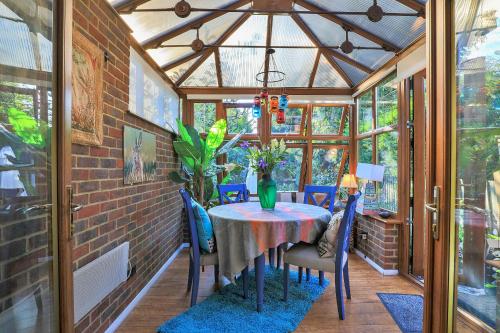 a conservatory dining room with a table and chairs at Finest Retreats - Bracken in Dormans Land