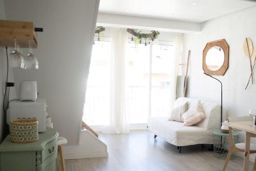 a living room with a white couch and a window at Duplex OverTheTejo, 5 min Belém Tower in Lisbon