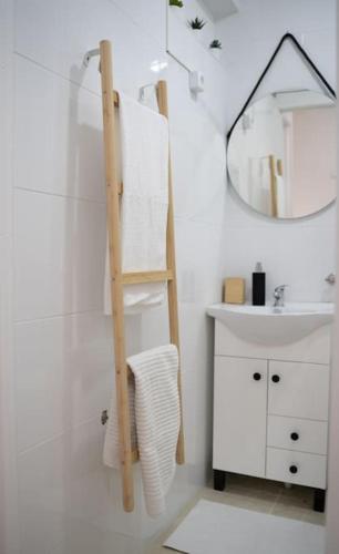 a bathroom with a ladder next to a sink and a mirror at Duplex OverTheTejo, 5 min Belém Tower in Lisbon