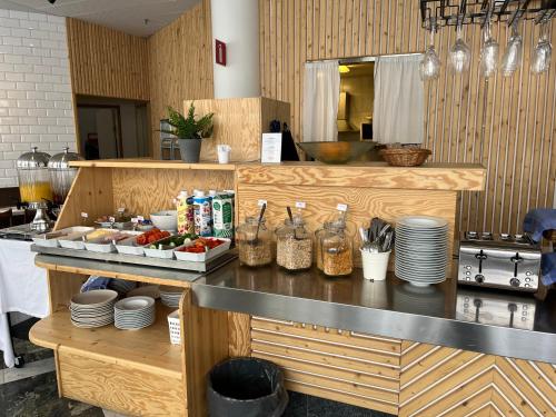 a kitchen with a counter with food on it at 2Home Hotel Apartments in Solna