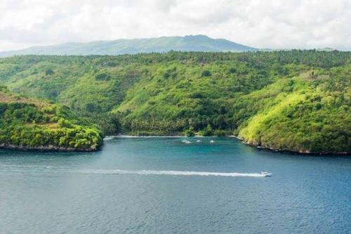 a boat in the middle of a river at Sakti OceanView Nusa Penida in Nusa Penida