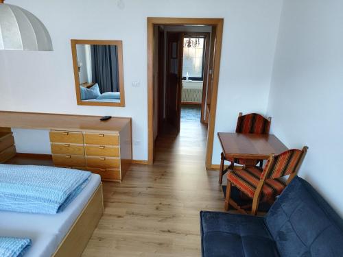a bedroom with a bed and a desk and a chair at Kehrerhof in Rifiano
