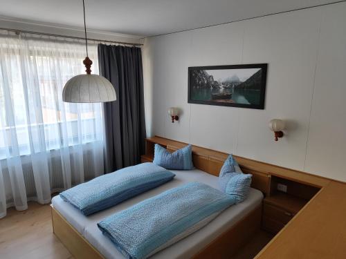 a bedroom with a couch with blue pillows on it at Kehrerhof in Rifiano