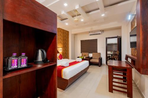a hotel room with a bed and a desk at Daan Orchid Residency in Kottayam