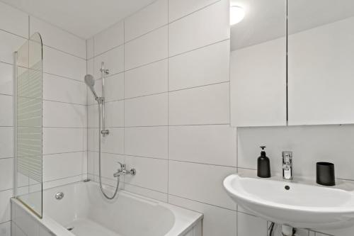 a white bathroom with a sink and a shower at FarawayHomes Studio Bruck an der Mur #4 in Bruck an der Mur