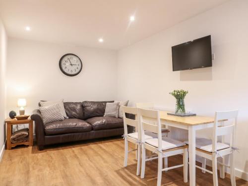 a living room with a couch and a table at Farley Cottage II in Alton